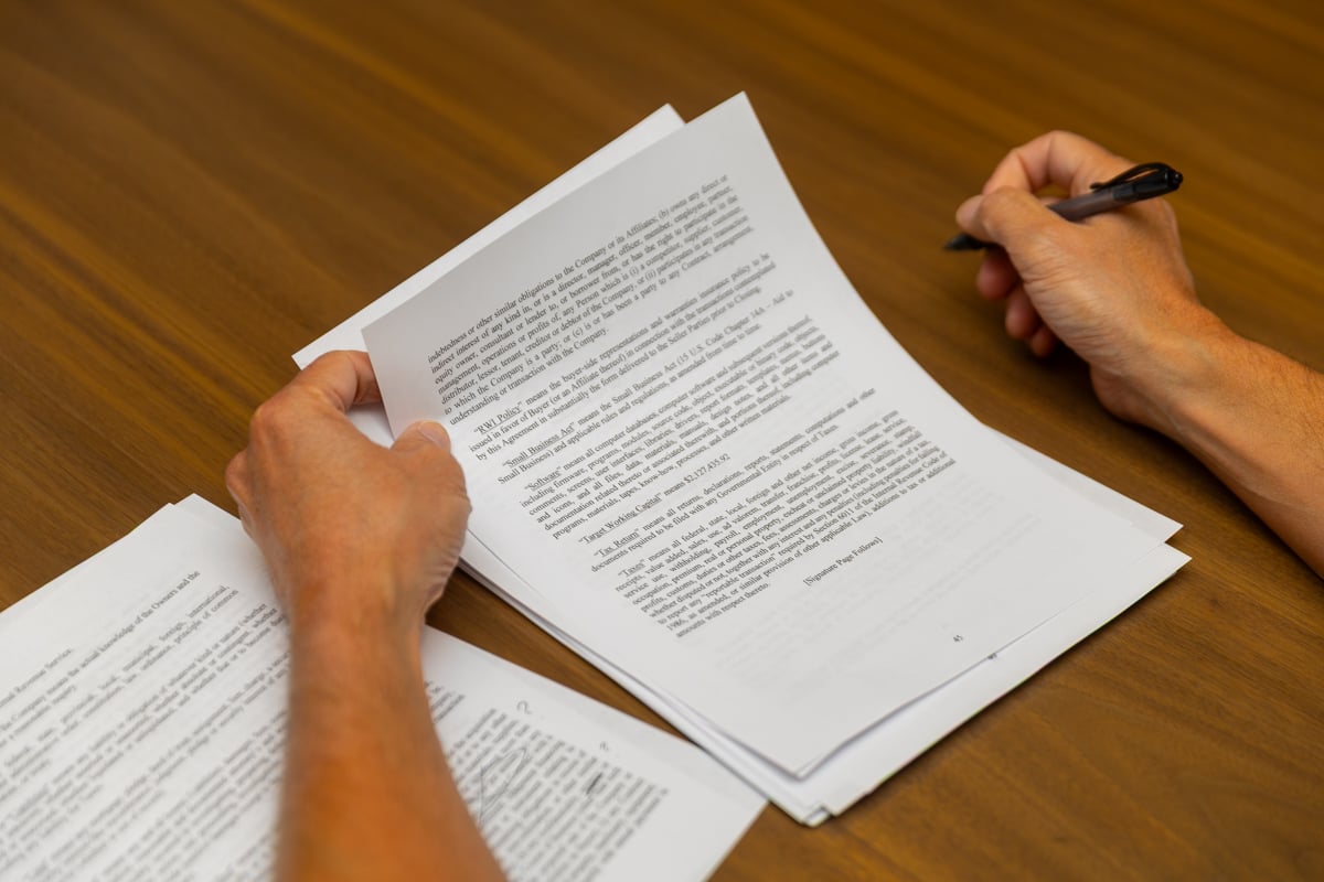 3PG-SXA office documents papers on a desk hands reviewing paperwork 9