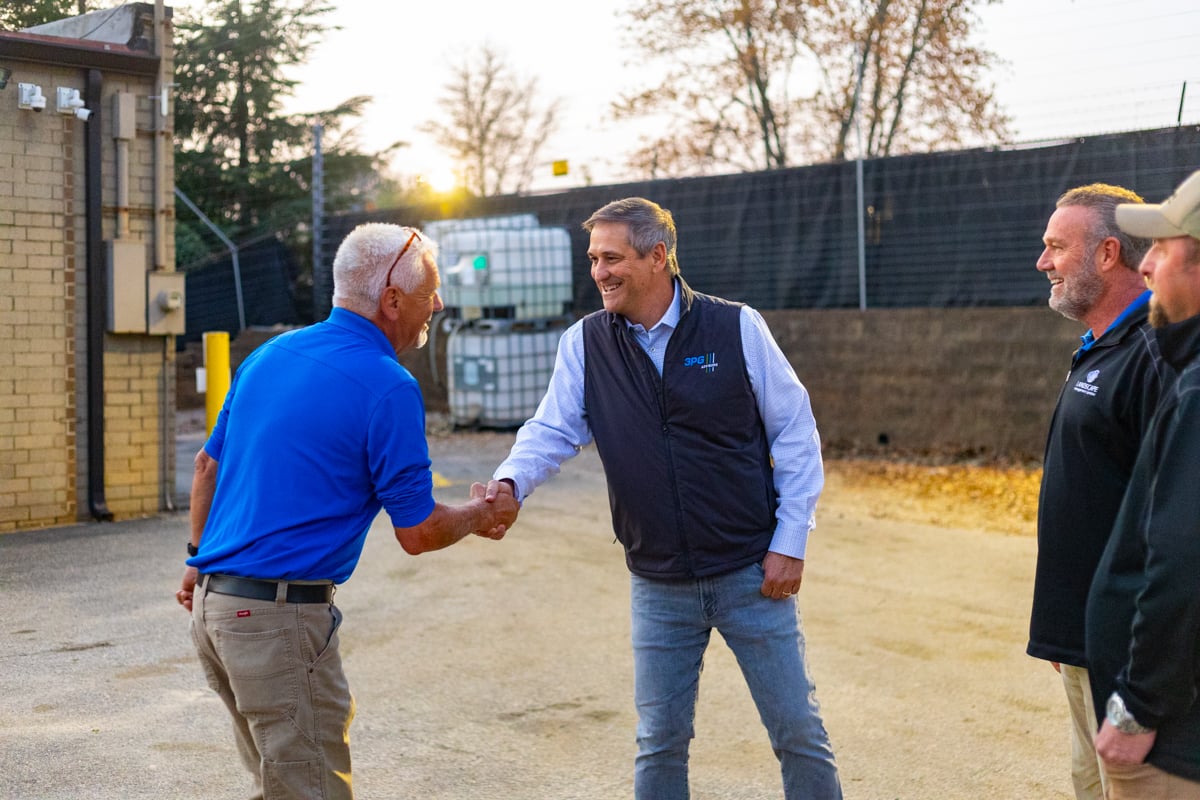landscape management services company owner jeff harkness and manager walking through yard & shop during morning rollout 6